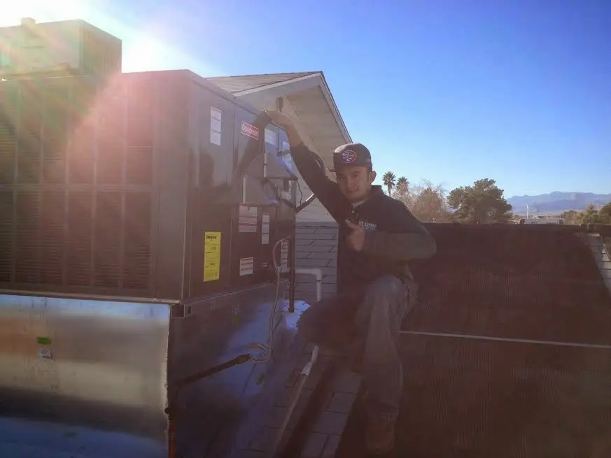 HVAC technician performing HVAC Inspection on a rooftop unit in Acworth